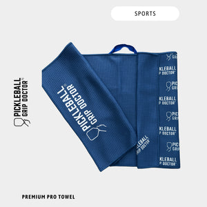 Blue sports towel with Pickleball Grip Doctor branding on a light gray background