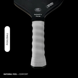 Pickleball paddle with black top and white handle on a black background