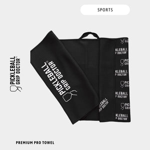Black towel with 'Pickleball Grip Doctor' branding on a white background