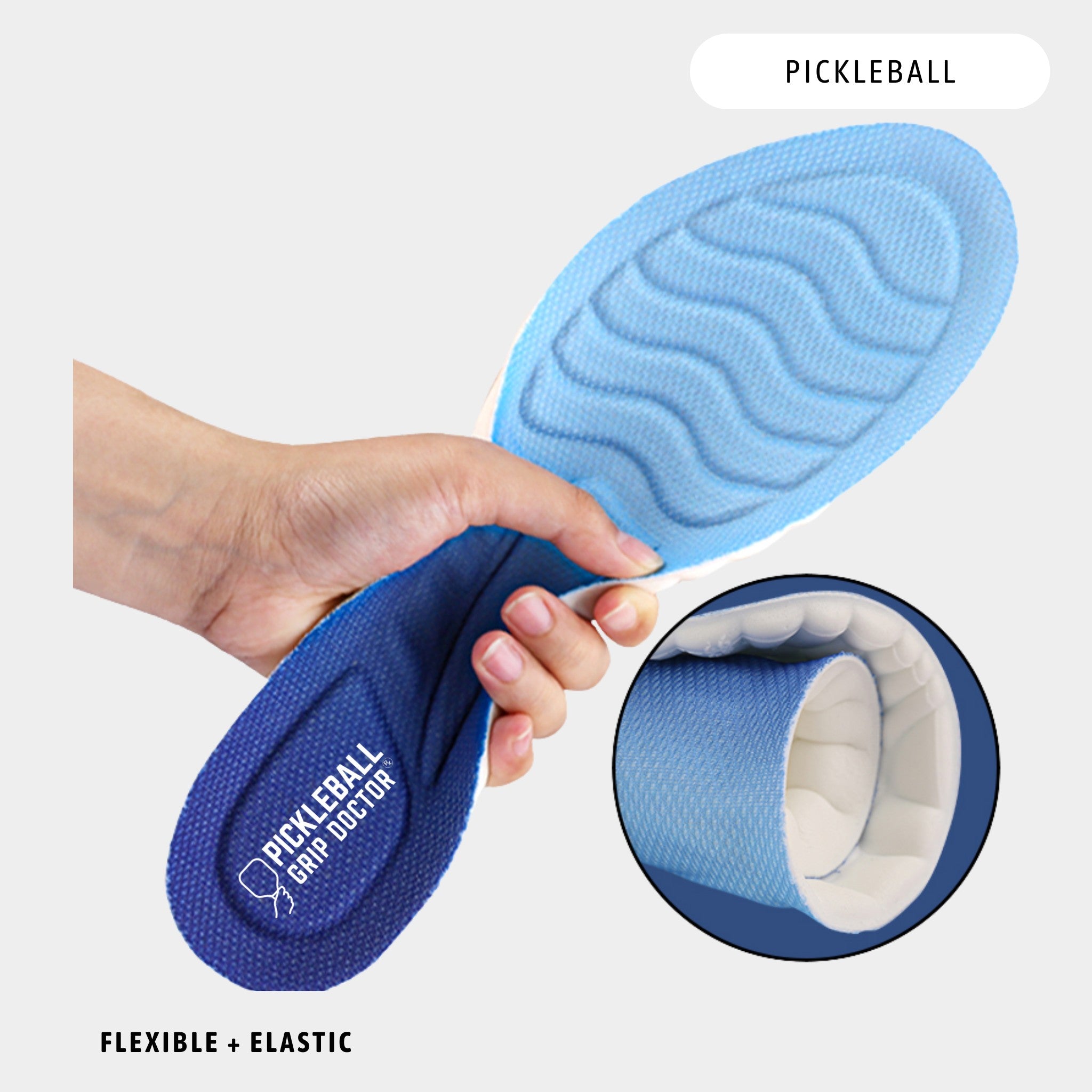 Blue pickleball grip doctored shoe insole held by a hand with close-up of sole texture.