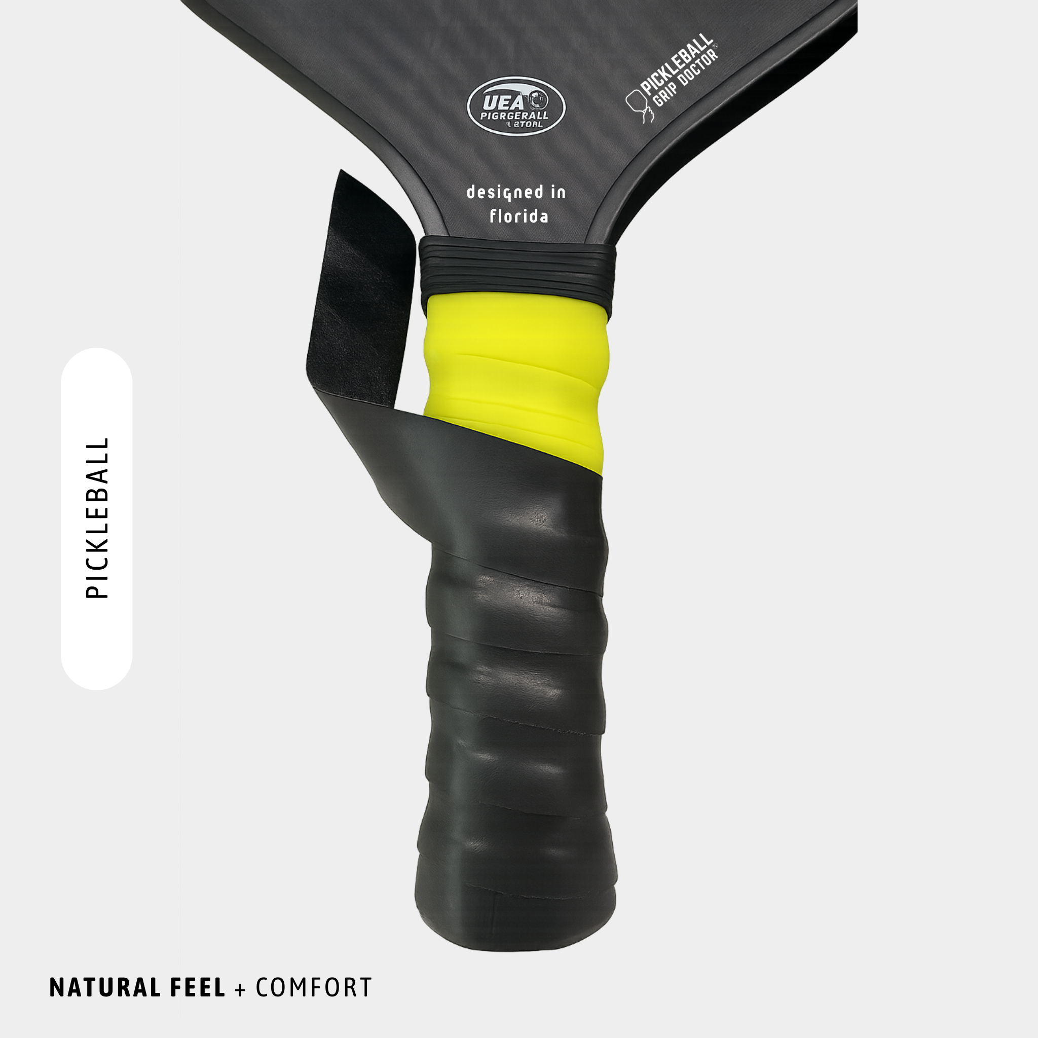 Close-up of a pickleball paddle with UEA branding on a white background