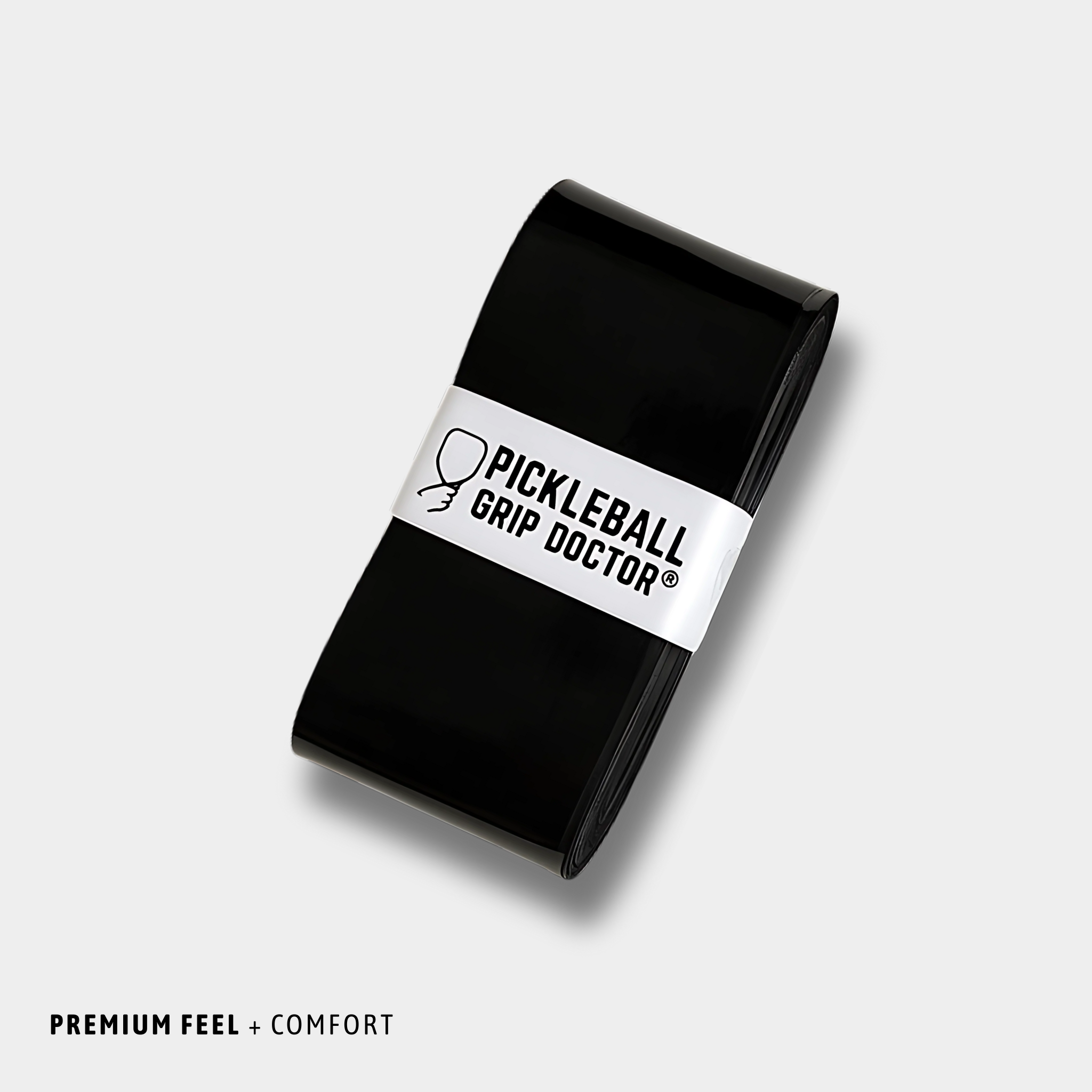 Black pickleball grip with 'Pickleball Grip Doctor' label on a light gray background